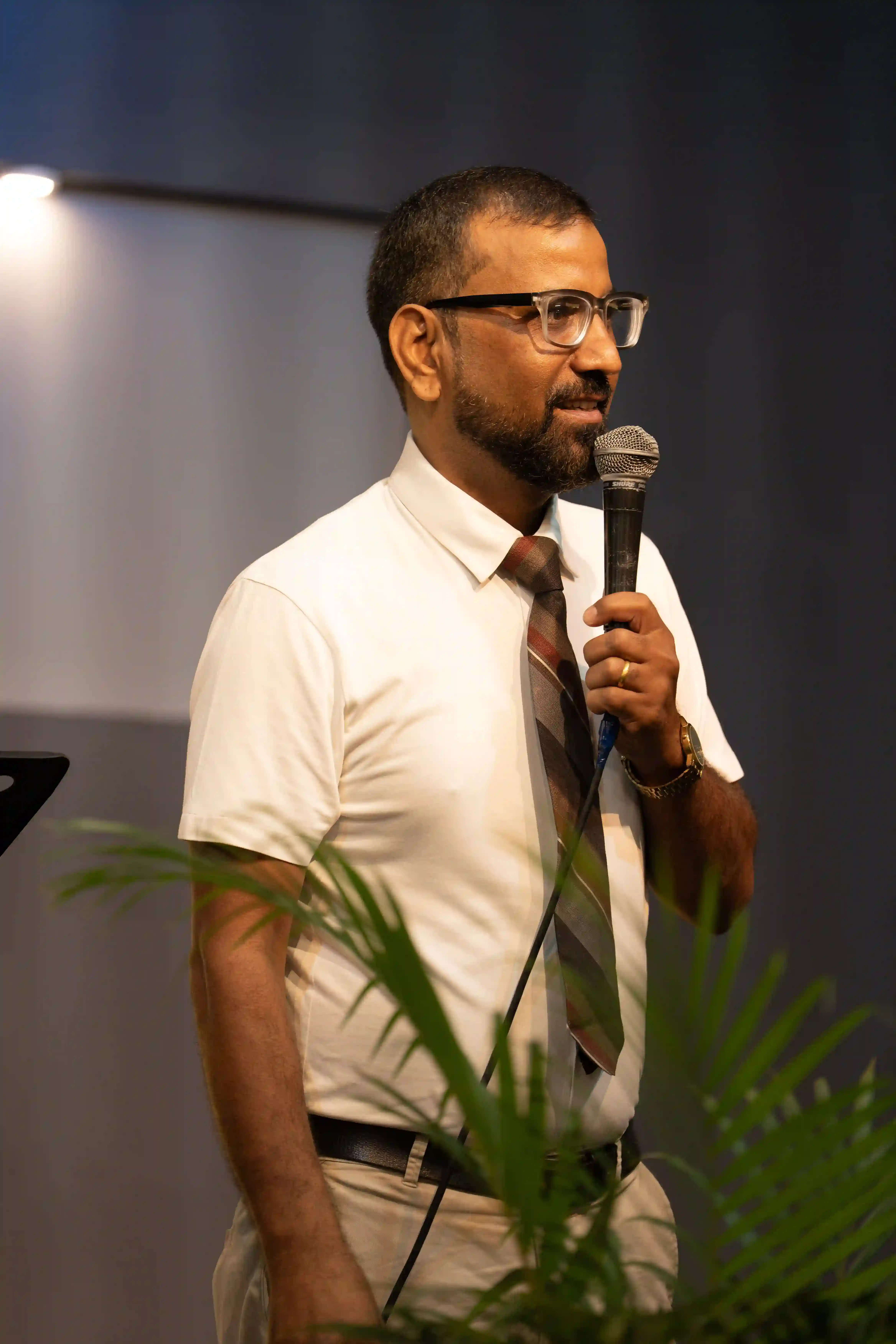 Pastor speaking during a GHNC TV broadcast in Bangalore